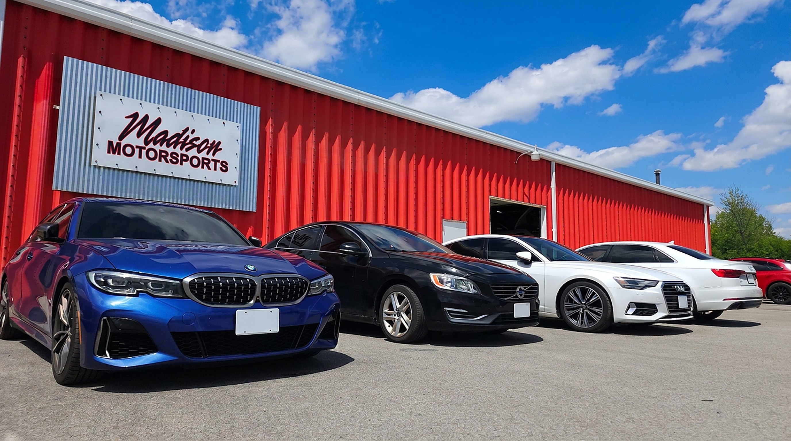 BMW, Volvo and Audi parked outside the Madison Motorsports storefront