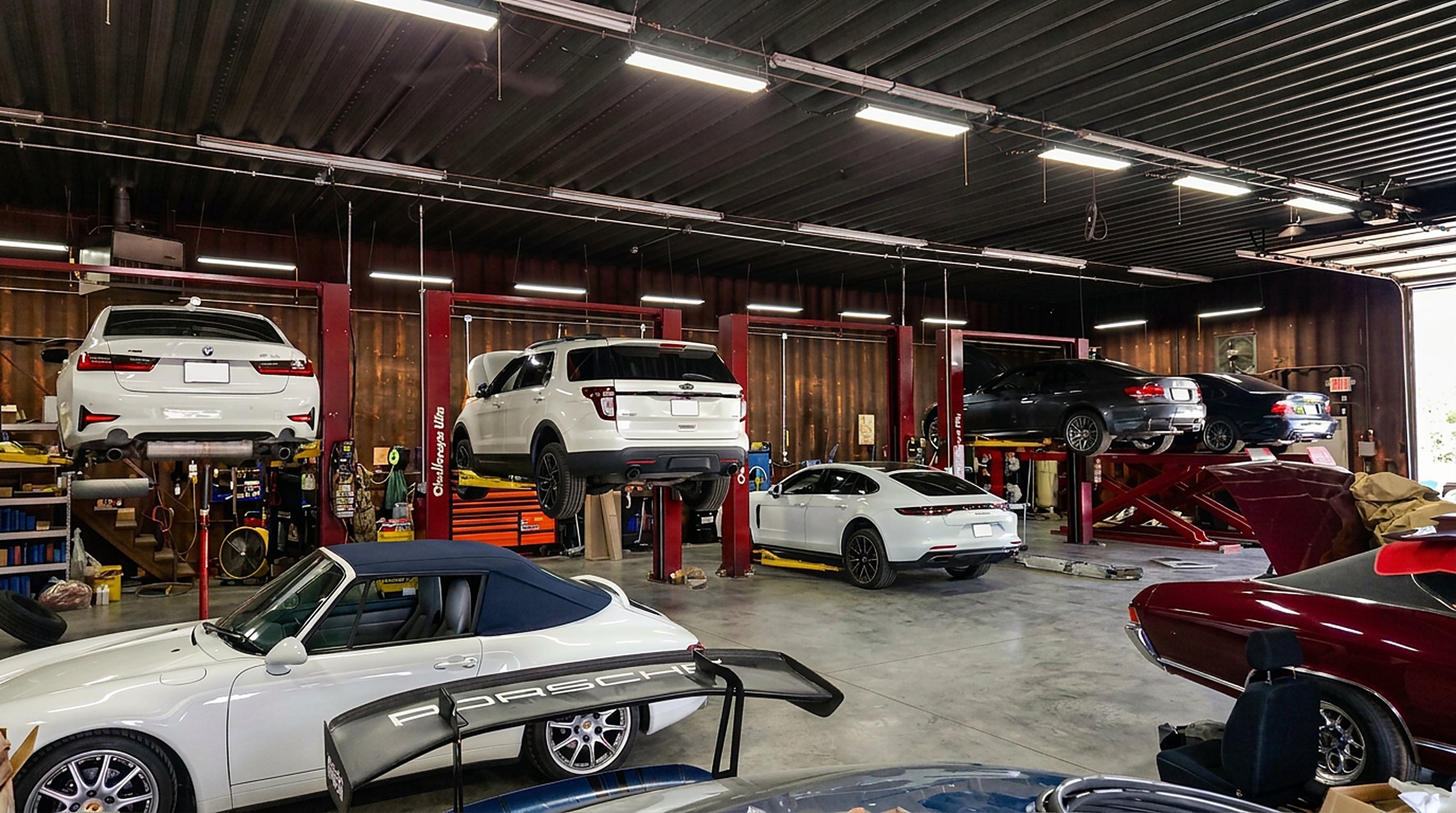 BMW, Ford and Porsche Panamera on lifts inside the Madison Motorsports service bays