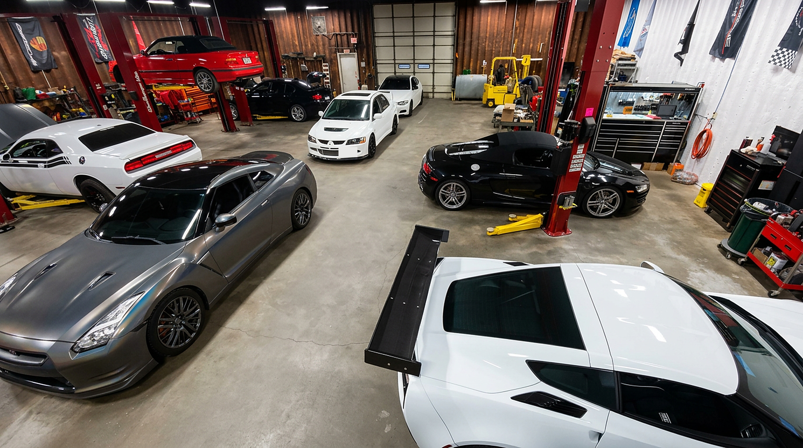 Corvette, GT-R, Audi R8 and Evo parked inside the Madison Motorsports shop